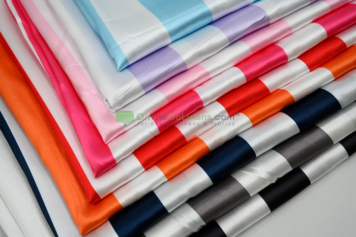 Stack of colorful fabric swatches in various colors on a light gray background.
